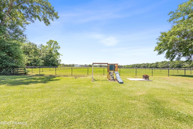 view of jungle gym with fence and a yard