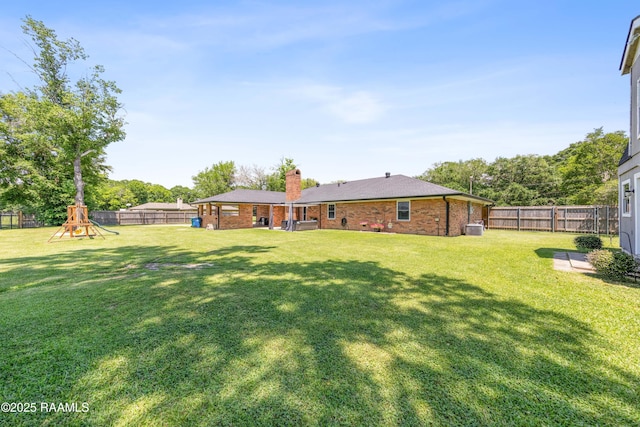 view of yard with a playground and a fenced backyard