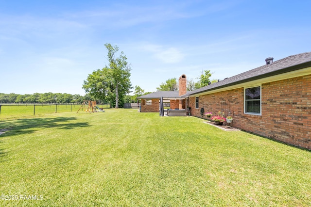 view of yard featuring a fenced backyard and a playground