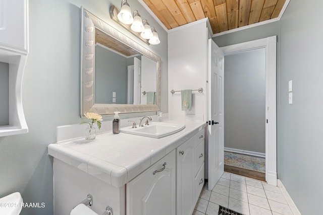 bathroom featuring wood ceiling, baseboards, toilet, vanity, and tile patterned flooring