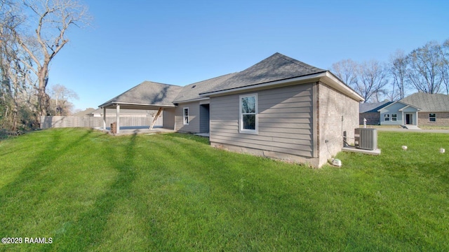 back of house with a lawn, fence, central air condition unit, and a patio