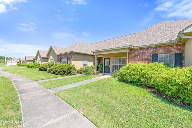 4000 Mchugh Rd Unit 102, Zachary, LA 70791 - ranch-style house with roof with shingles, a front yard, and brick siding