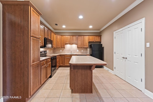 4000 Mchugh Rd Unit 102, Zachary, LA 70791 - kitchen with black appliances, tile countertops, a sink, crown molding, and tasteful backsplash