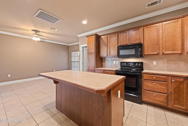 4000 Mchugh Rd Unit 102, Zachary, LA 70791 - kitchen featuring black appliances, tile counters, light tile patterned flooring, a breakfast bar, and ornamental molding