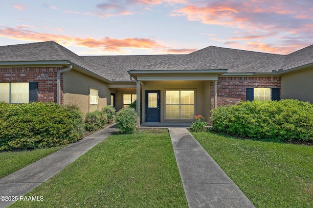 4000 Mchugh Rd Unit 102, Zachary, LA 70791 - view of front of property featuring a shingled roof, a front yard, and brick siding