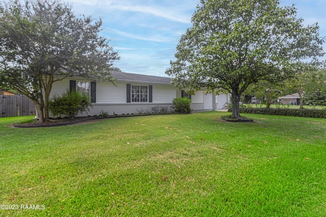 110 Karen Dr, Lafayette, LA 70503 - view of front facade featuring fence, a front yard, and an attached garage