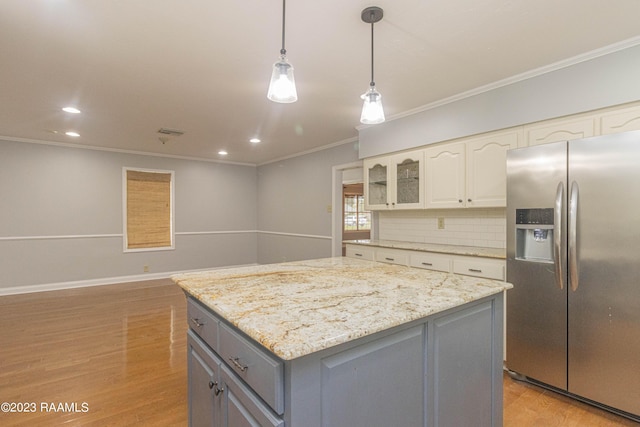 110 Karen Dr, Lafayette, LA 70503 - kitchen with gray cabinets, light wood-type flooring, a center island, ornamental molding, and stainless steel fridge with ice dispenser