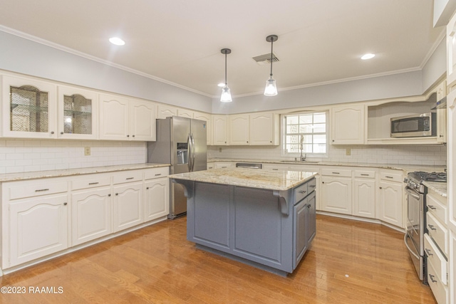 110 Karen Dr, Lafayette, LA 70503 - kitchen featuring tasteful backsplash, a center island, visible vents, ornamental molding, and appliances with stainless steel finishes