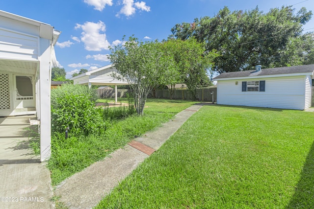 110 Karen Dr, Lafayette, LA 70503 - view of yard featuring fence and an outbuilding
