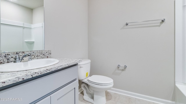 bathroom featuring a bathing tub, tile patterned flooring, toilet, vanity, and baseboards