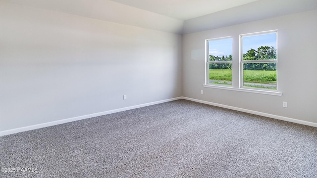 spare room featuring carpet floors and baseboards