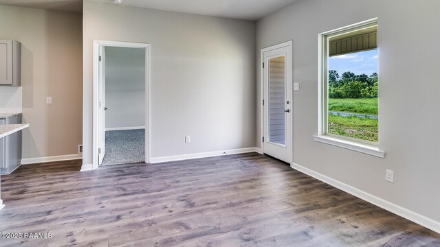 interior space featuring baseboards and wood finished floors