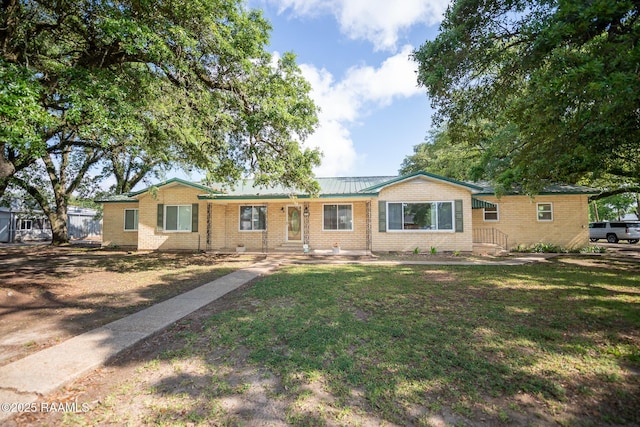 ranch-style home with brick siding and a front yard