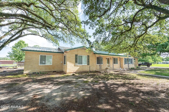 view of front of house with brick siding and metal roof
