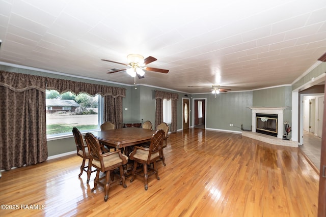 dining area featuring ornamental molding, a ceiling fan, and light wood-type flooring