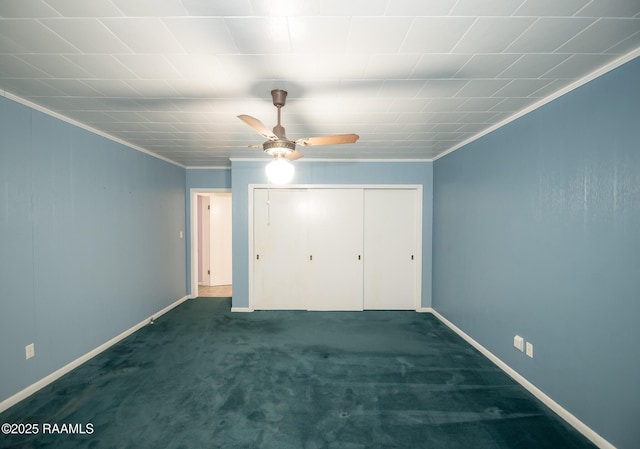 unfurnished bedroom with crown molding, a closet, baseboards, a ceiling fan, and carpet