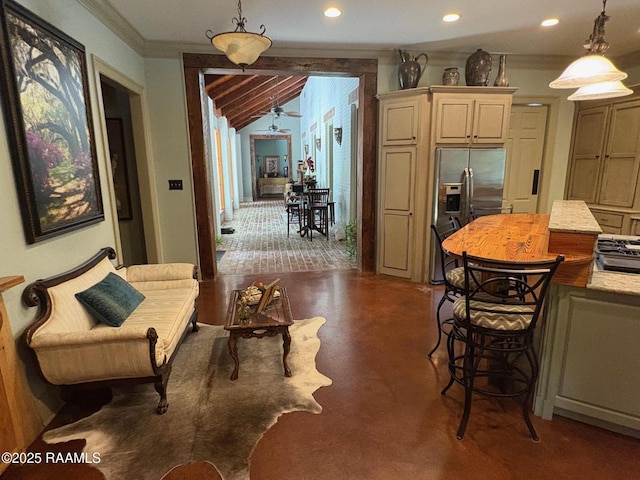 10427 U S Highway 167, Abbeville, LA 70510 - kitchen featuring crown molding, a kitchen bar, recessed lighting, stainless steel fridge, and hanging light fixtures