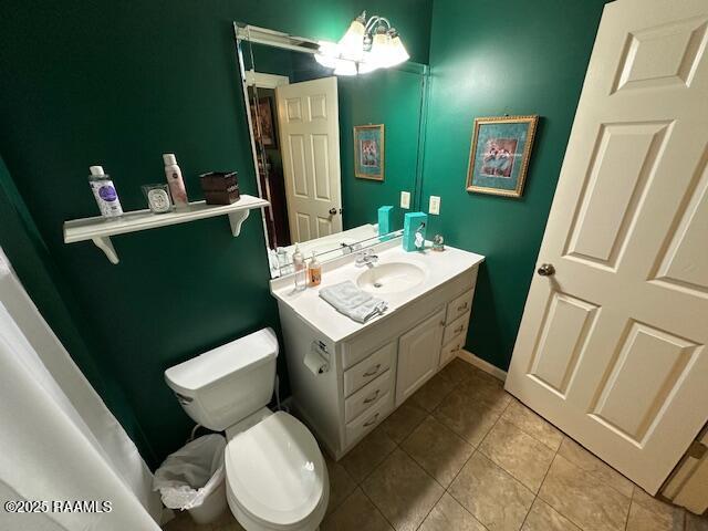 10427 U S Highway 167, Abbeville, LA 70510 - bathroom featuring toilet, tile patterned flooring, and vanity