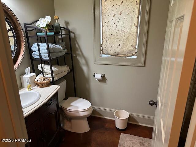 10427 U S Highway 167, Abbeville, LA 70510 - half bath with baseboards, toilet, and vanity