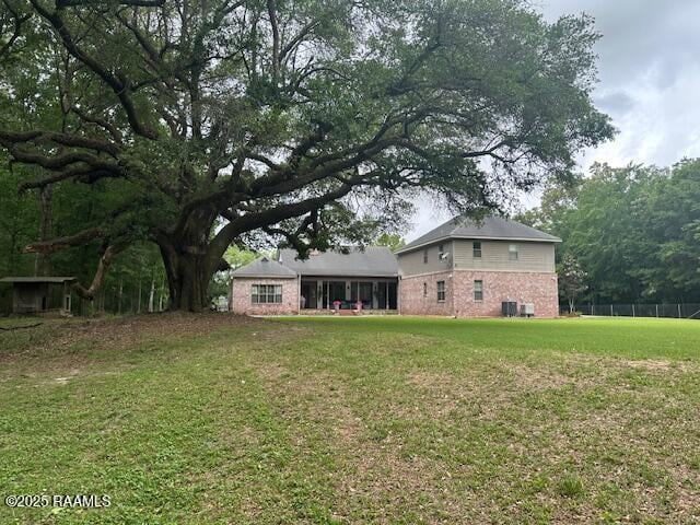10427 U S Highway 167, Abbeville, LA 70510 - back of house with a lawn and brick siding