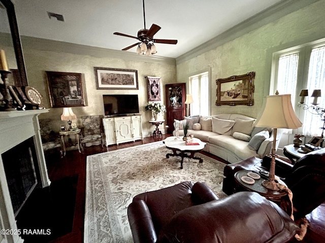 10427 U S Highway 167, Abbeville, LA 70510 - living area with visible vents, ornamental molding, dark wood-style flooring, a fireplace, and a ceiling fan