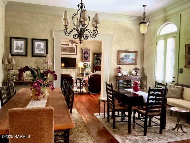 10427 U S Highway 167, Abbeville, LA 70510 - dining space featuring an inviting chandelier, crown molding, and wood finished floors