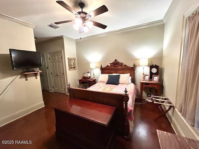 10427 U S Highway 167, Abbeville, LA 70510 - bedroom with a ceiling fan, baseboards, wood finished floors, visible vents, and ornamental molding