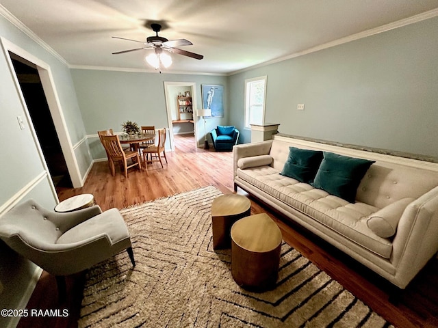 10427 U S Highway 167, Abbeville, LA 70510 - living area featuring a ceiling fan, baseboards, ornamental molding, and wood finished floors