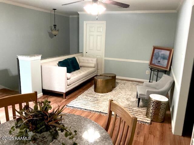 10427 U S Highway 167, Abbeville, LA 70510 - interior space with baseboards, ornamental molding, ceiling fan, and wood finished floors