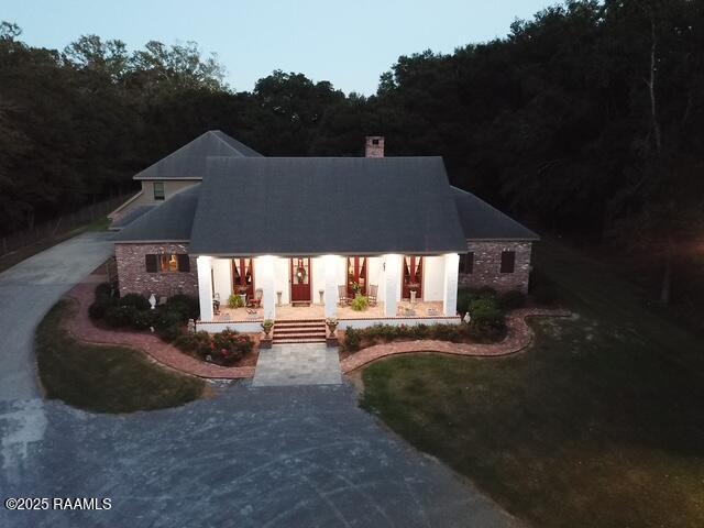 10427 U S Highway 167, Abbeville, LA 70510 - view of front of home with covered porch and a chimney