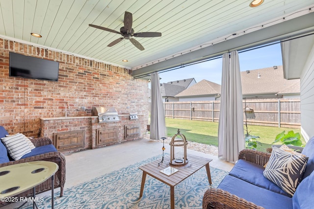 exterior space with ceiling fan and an outdoor kitchen