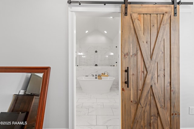 bathroom featuring walk in shower, a freestanding bath, lofted ceiling, and marble finish floor