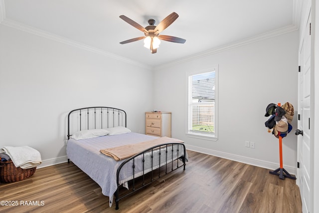bedroom with baseboards, ornamental molding, and wood finished floors