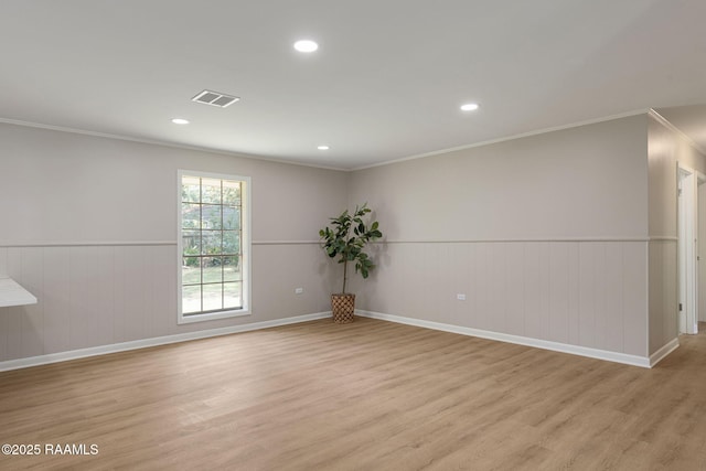 204 Tillou Andrus Dr, Opelousas, LA 70570 - spare room with visible vents, ornamental molding, wainscoting, recessed lighting, and light wood-style flooring