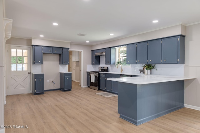 204 Tillou Andrus Dr, Opelousas, LA 70570 - kitchen with blue cabinets, light wood-type flooring, stainless steel gas stove, a peninsula, and ornamental molding