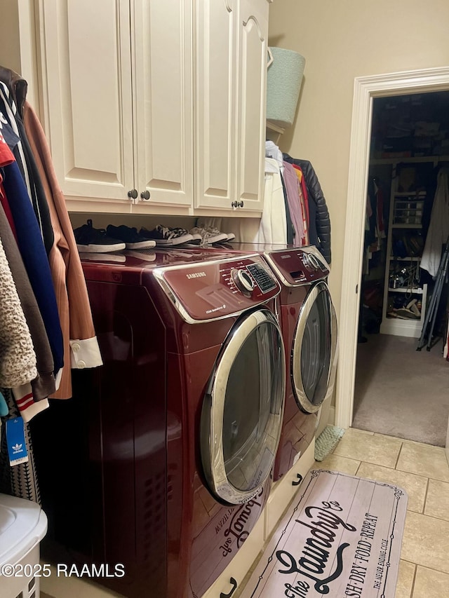 107 Octavia Dr, Scott, LA 70583 - clothes washing area with washer and dryer, cabinet space, light tile patterned flooring, and light colored carpet
