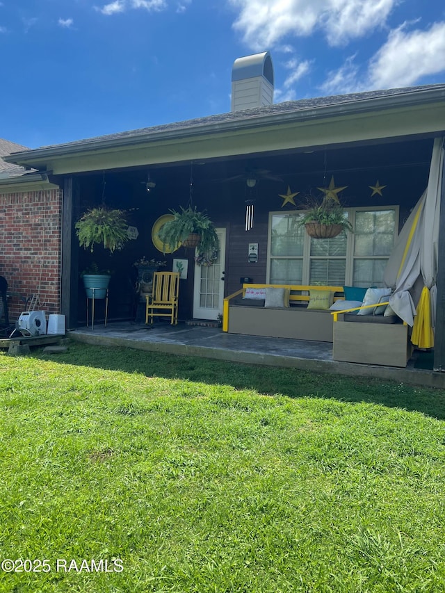 107 Octavia Dr, Scott, LA 70583 - rear view of house featuring a lawn, ceiling fan, and a chimney