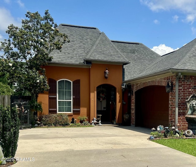 107 Octavia Dr, Scott, LA 70583 - view of front of home featuring a garage, driveway, a shingled roof, and brick siding