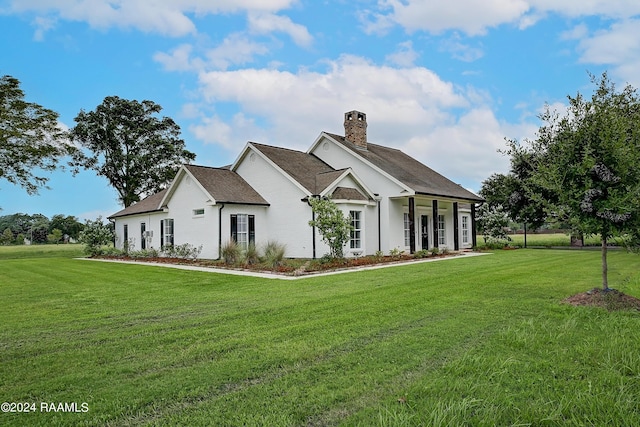 exterior space featuring a chimney and a yard