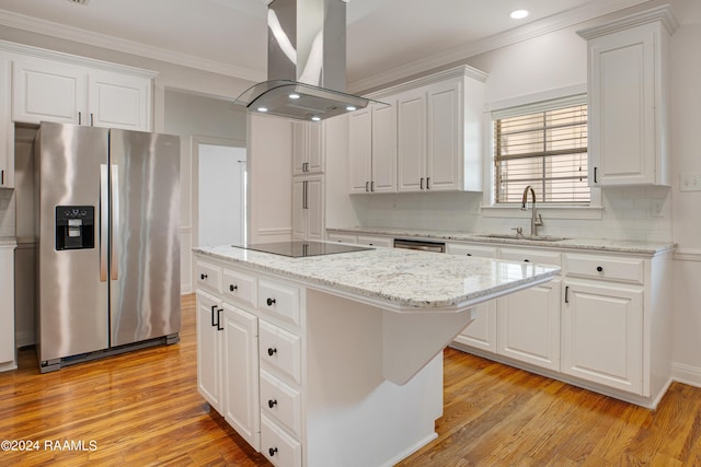 kitchen featuring crown molding, a sink, island range hood, a center island, and stainless steel fridge