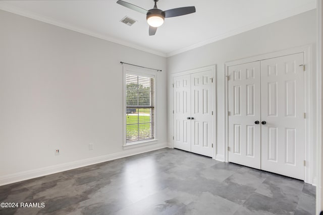 unfurnished bedroom with two closets, crown molding, a ceiling fan, visible vents, and baseboards