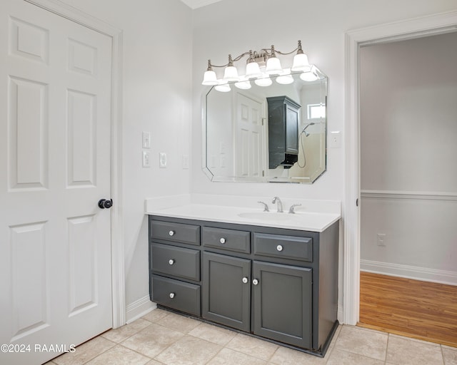 bathroom with tile patterned floors, vanity, and baseboards