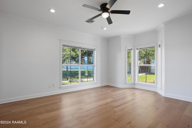 empty room featuring recessed lighting, visible vents, baseboards, ornamental molding, and wood finished floors