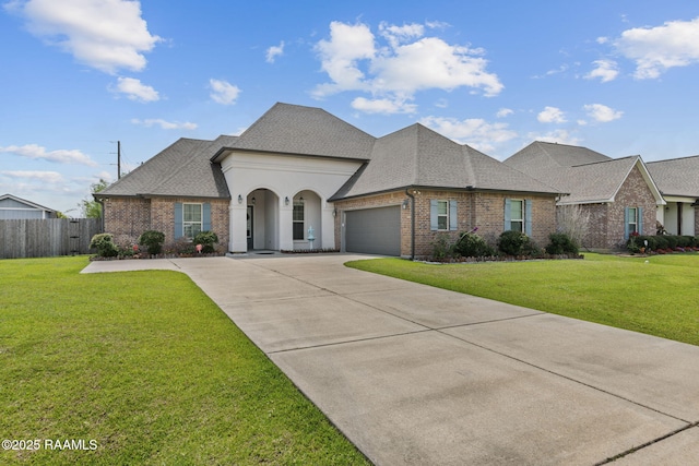 101 Marigold Ln, Maurice, LA 70555 - french provincial home with roof with shingles, brick siding, a garage, and concrete driveway