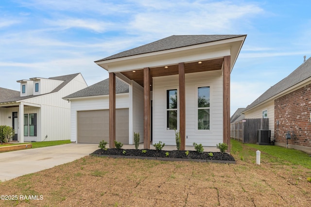 view of front of house with fence, driveway, and a front yard