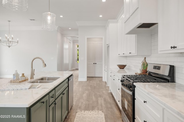 kitchen featuring recessed lighting, a sink, stainless steel appliances, backsplash, and white cabinets