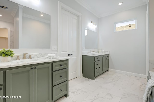 full bath with ornamental molding, two vanities, a sink, and marble finish floor
