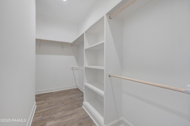 spacious closet with wood finished floors