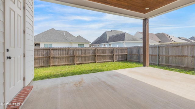 view of patio featuring a fenced backyard and a residential view