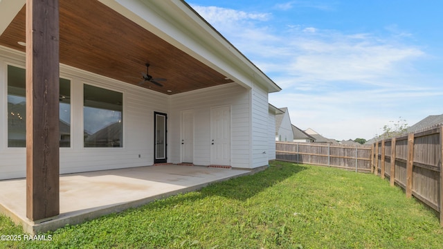 view of yard featuring ceiling fan, a fenced backyard, and a patio area